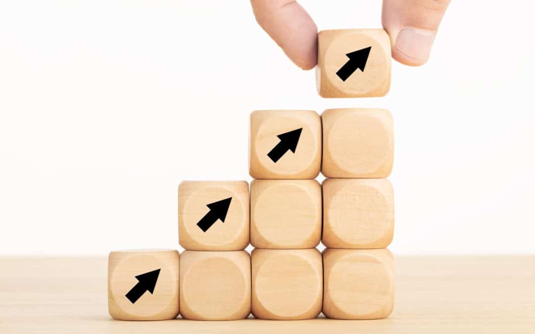 Business Growth Process Concept. Hand Holding A Wooden Block With Arrow Icon